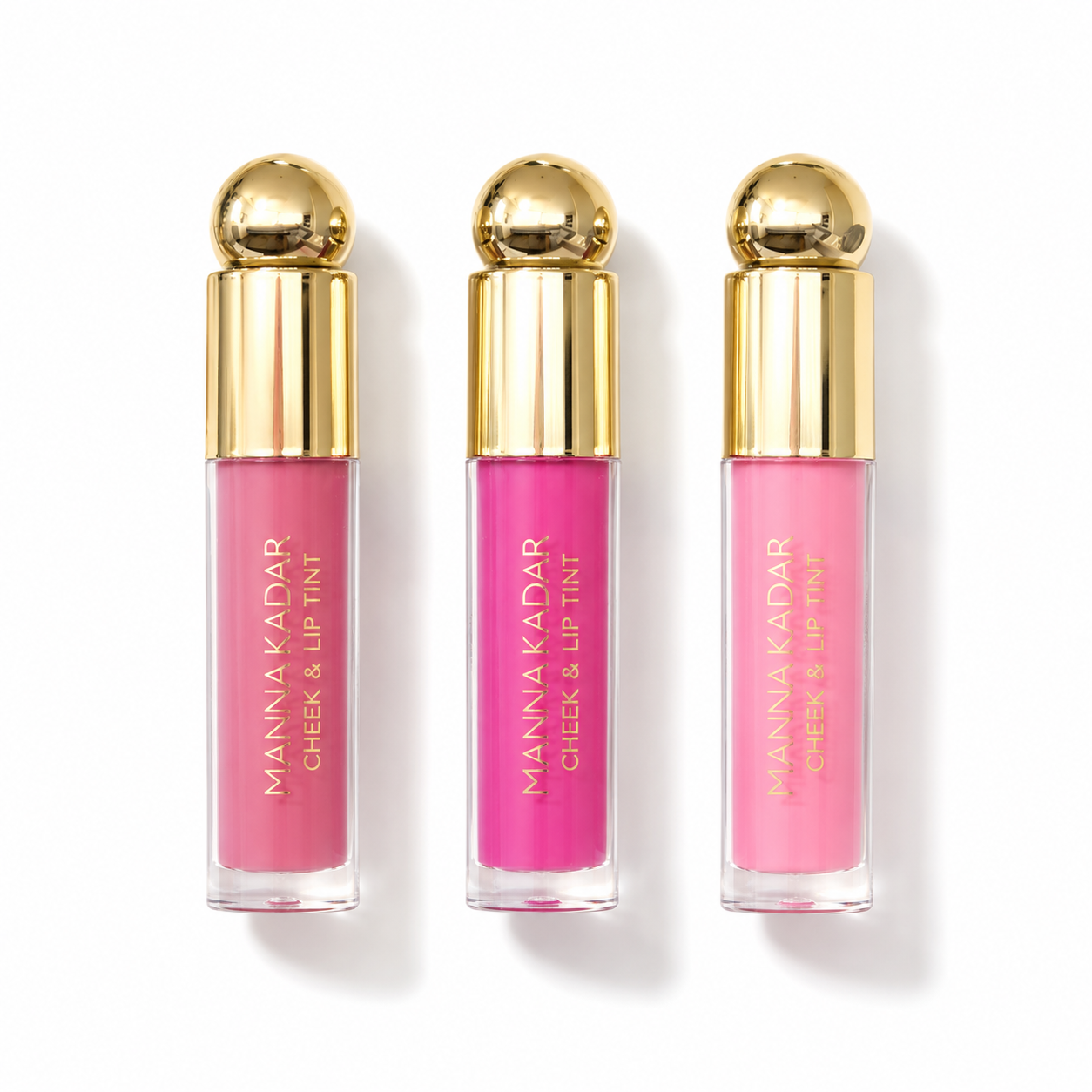 Three pink lip tint bottles with gold caps on a white background