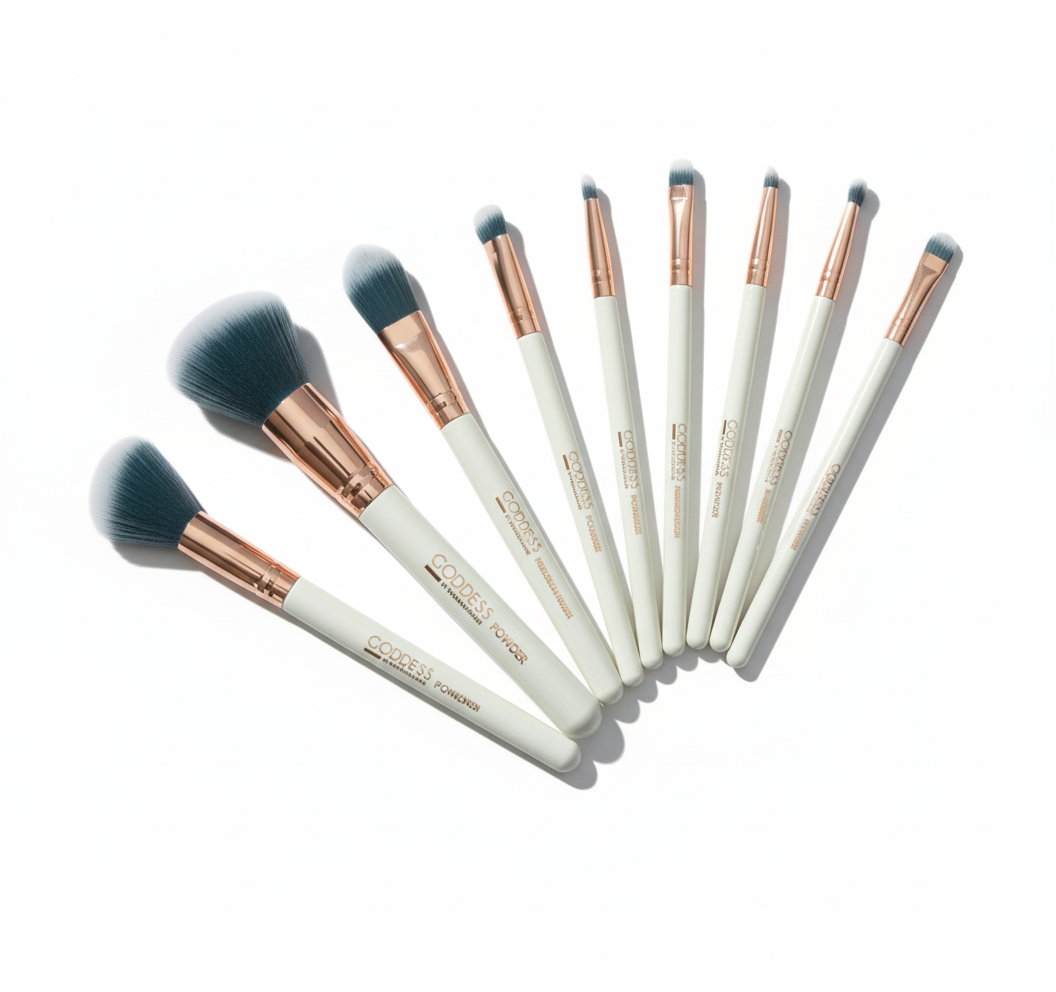 Set of makeup brushes with rose gold and white handles on a white background