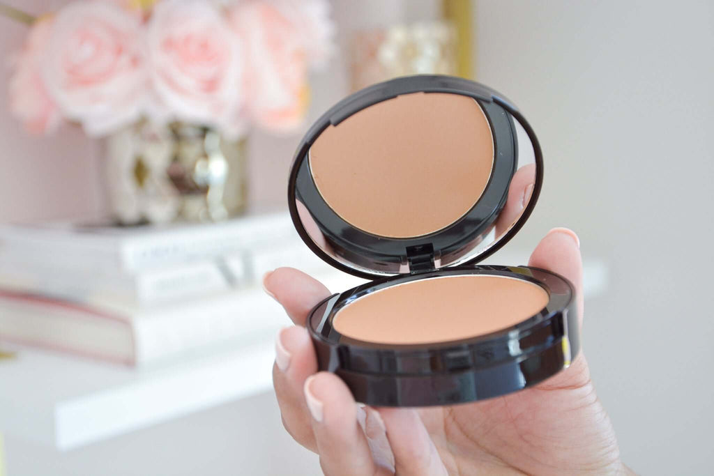 Flawless Finish Dual Powder by Manna Kadar being held in hand showing mirror inside compact
