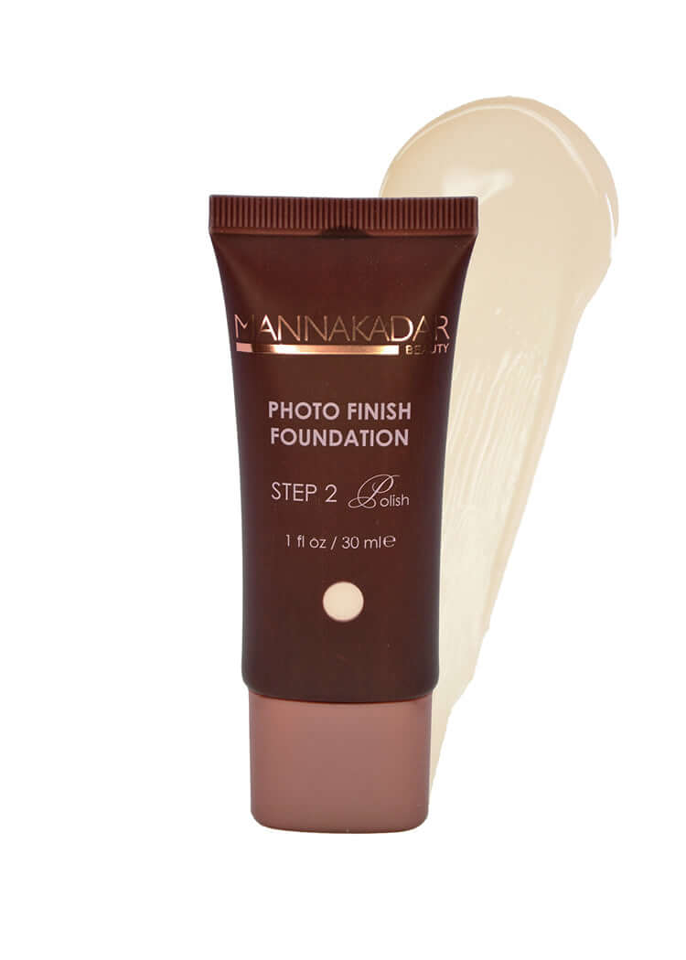 Photo Finish Foundation Manna Kadar brown squeeze tube foundation bottle show with lightest pale porcelain swatch behind bottle.