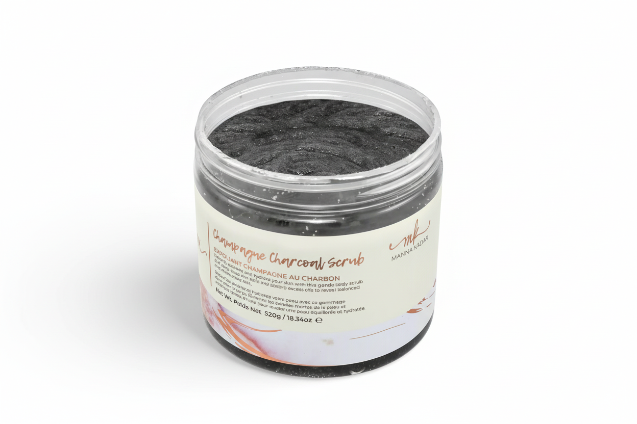 A clear jar containing black charcoal body scrub, with a pink label that includes product details.