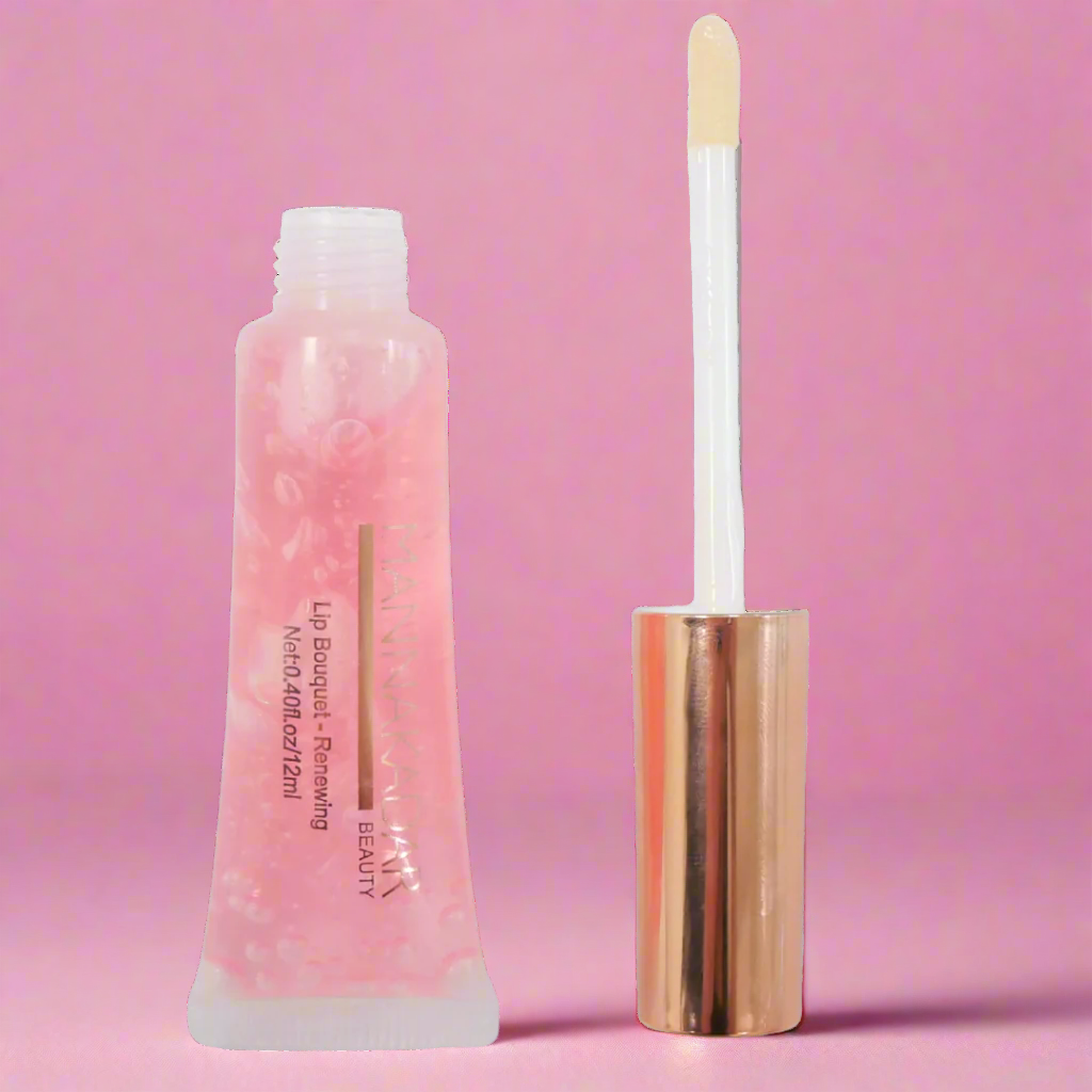 97286-RenewingLipBalmOpen by Manna Kadar open lip gloss tube on pink background