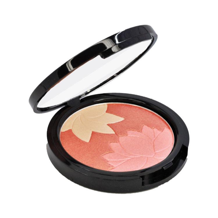 Blossom Floral Compact Manna Kadar half open showing mirror and product. Blossom has  florar patter with one flower cut into the powder that is a golden highlighter, one flower is a pale pink shimmer and the background is a peach blush. All shades can be mixed or used alone.